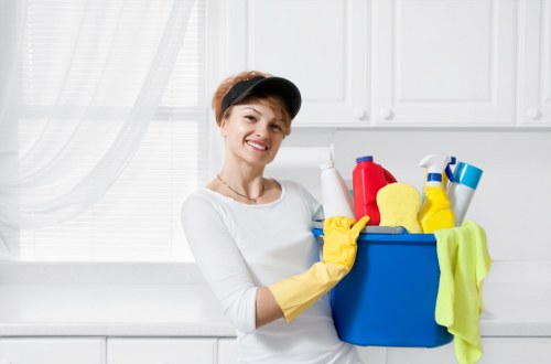 Cleaning staff sanitizing a shared hallway and lift area
