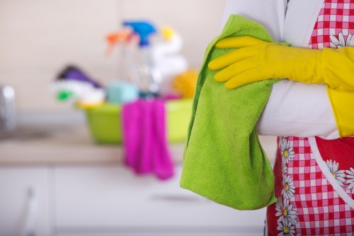 Professional cleaner dusting surfaces during one off cleaning